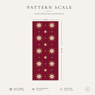 Pattern scale of the Stars Christmas table runner in burgundy and gold across its 44 cm width, with care notes