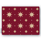 Stars Christmas tablecloth in burgundy and gold, folded on white, showing gold eight-pointed stars