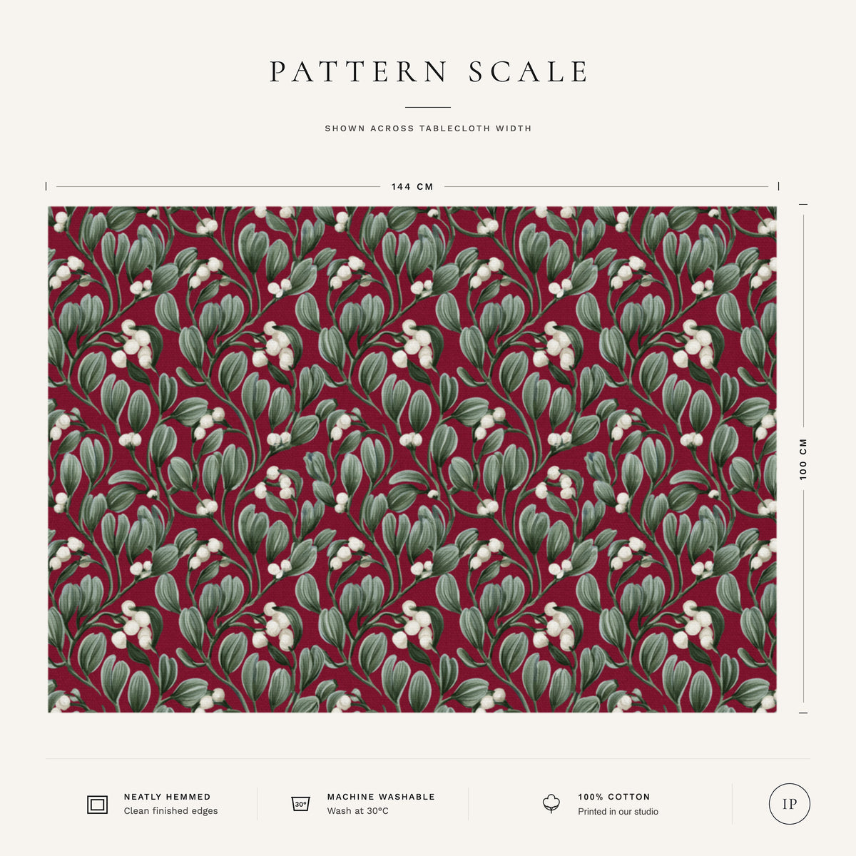 Pattern scale of the Mistletoe Christmas tablecloth in burgundy across its 144 cm width, with care notes