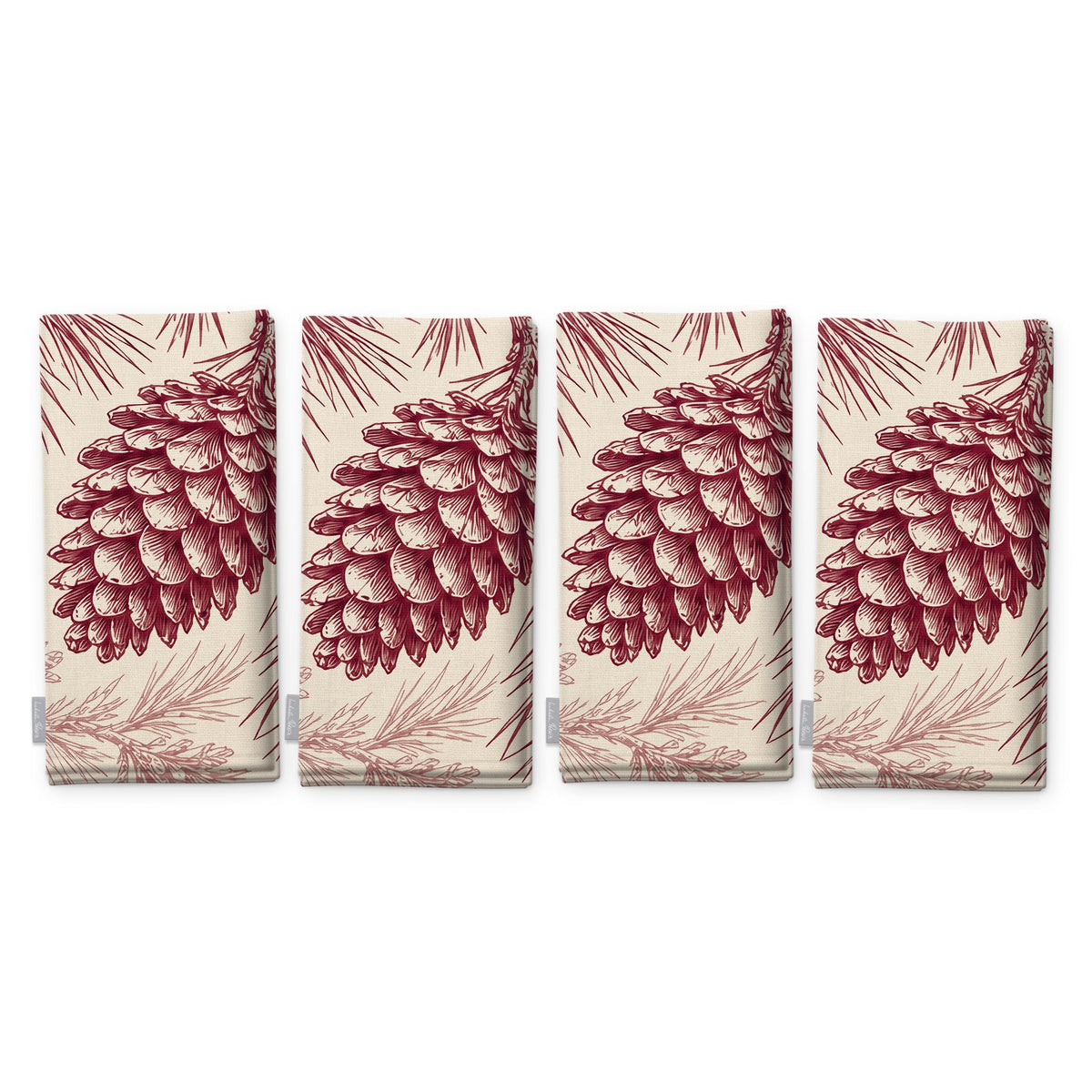 Pine Bough Christmas napkins in burgundy on ivory, set of four, folded on white, showing the same pine cone on a bough
