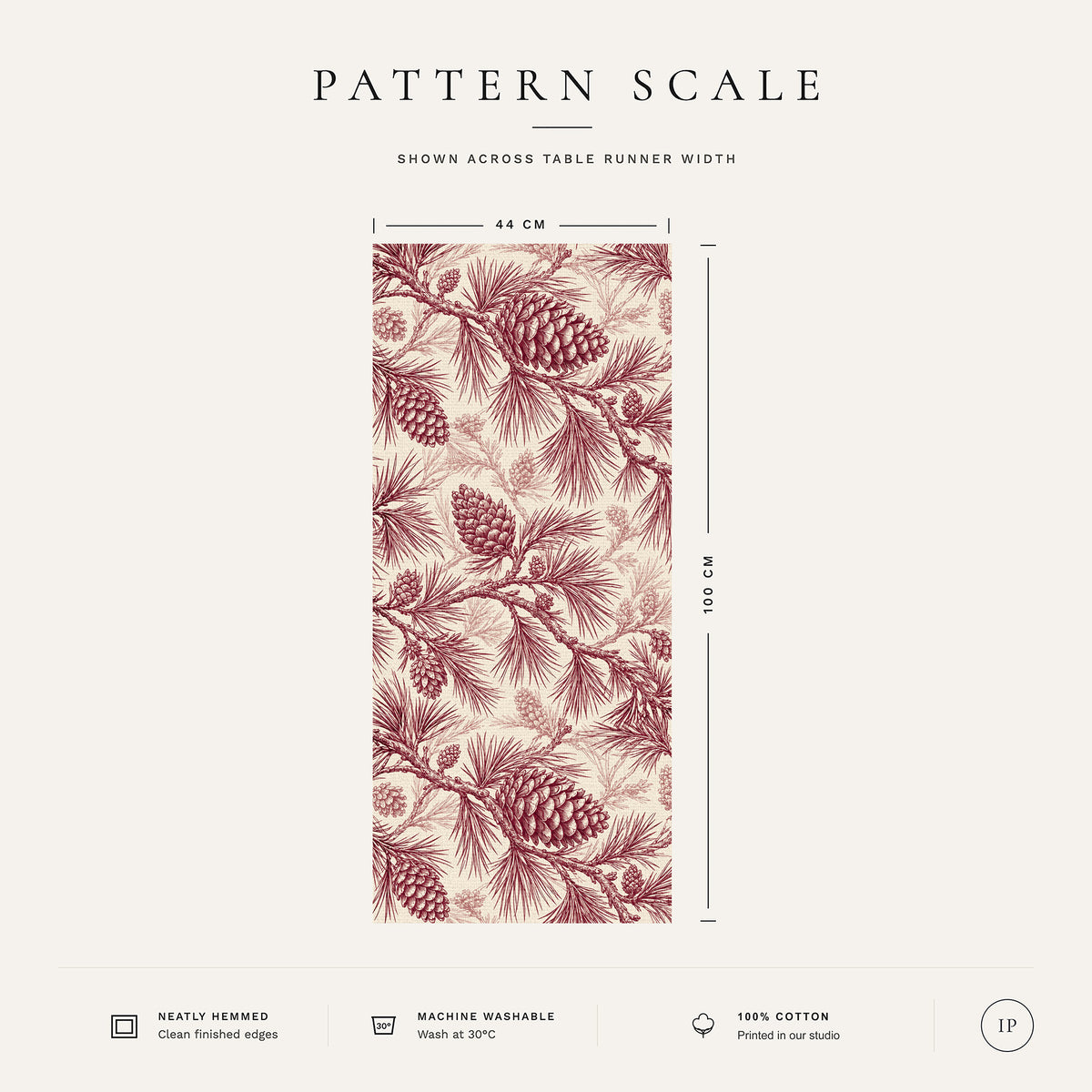 Pattern scale of the Pine Bough Christmas table runner in burgundy on ivory across its 44 cm width, with care notes
