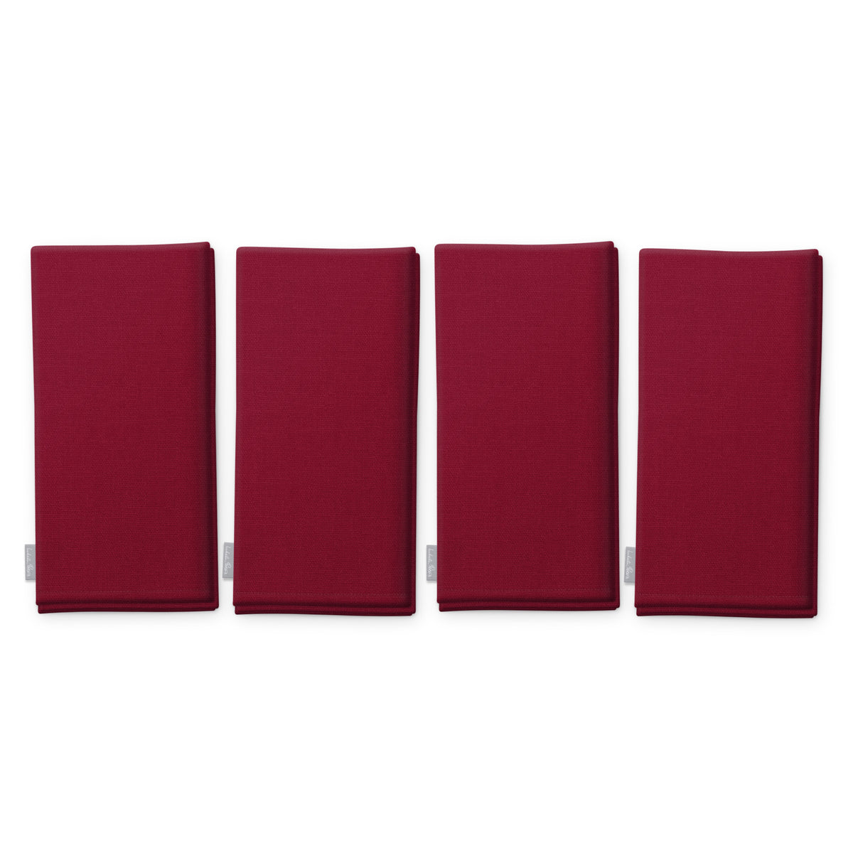 Plain burgundy cotton Christmas napkins, set of four, folded on white