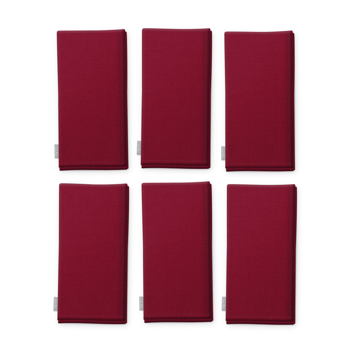 Plain burgundy cotton Christmas napkins, set of six, folded on white