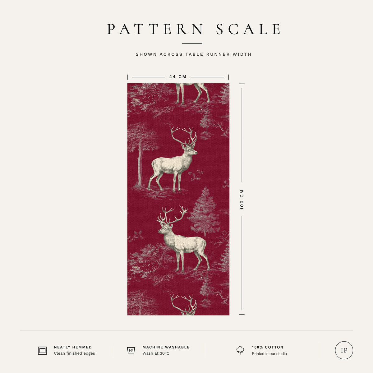 Pattern scale of the burgundy Stag Woodland Christmas table runner across its 44 cm width, with fabric and care notes