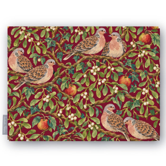 Burgundy Turtle Doves and Mistletoe Christmas tablecloth folded on white, showing turtle doves among mistletoe and red apples