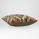 Angled view showing the front and Deep Olive plain reverse of a Court Medallion rectangular cushion in Olive & Tomato, finished with Tomato piping.