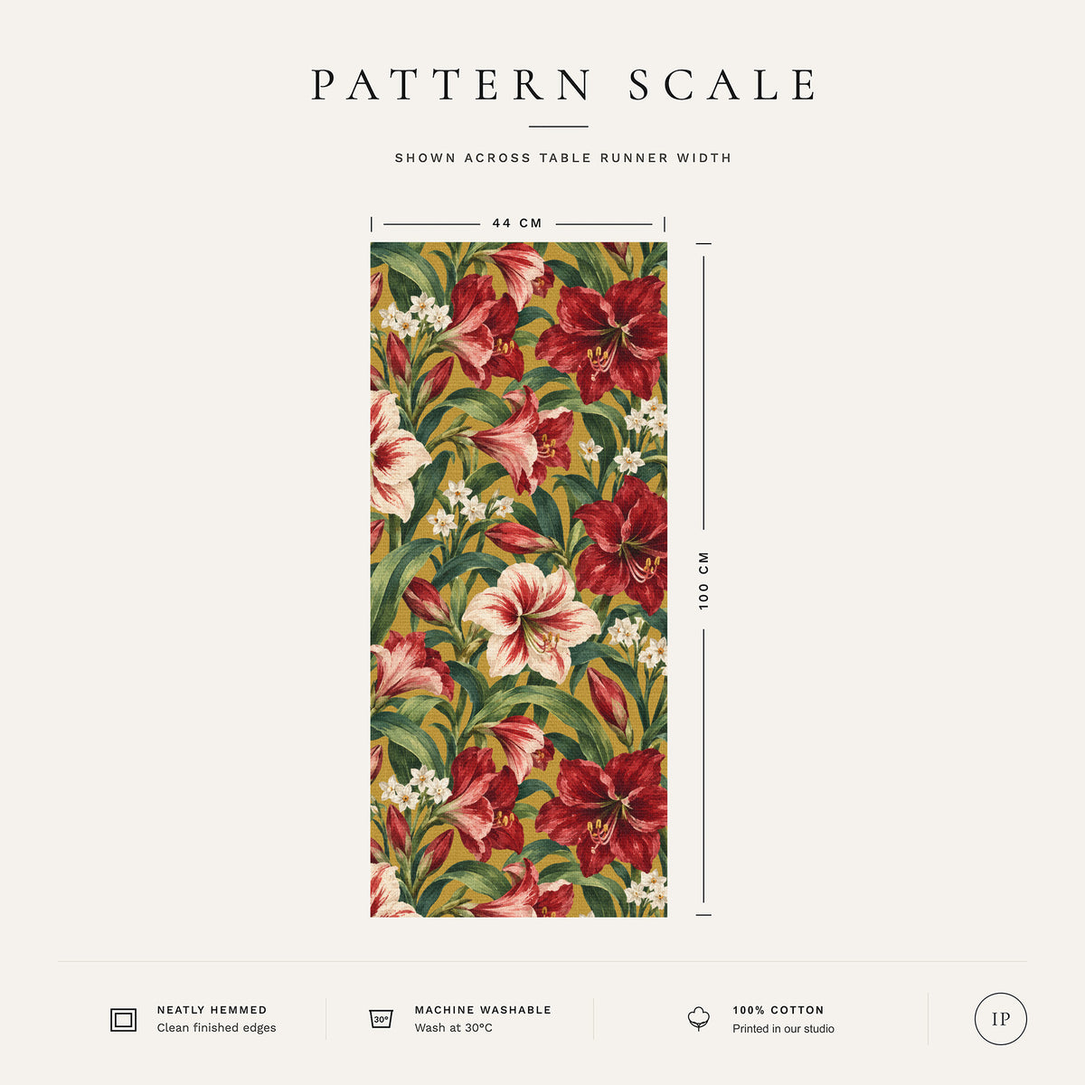 Pattern scale of the Amaryllis Christmas table runner in gold across its 44 cm width, with care notes