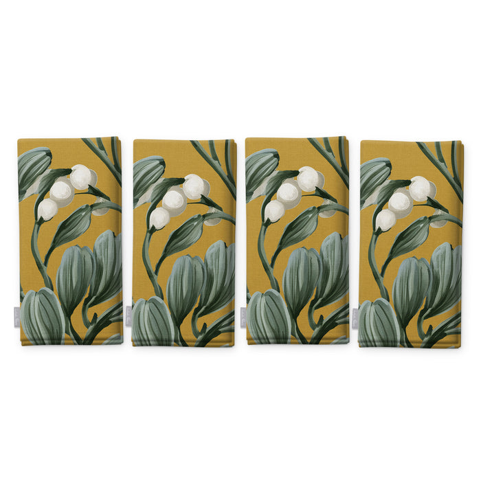 Gold Mistletoe Christmas napkins, set of four, folded on white, showing the same sprig of mistletoe with white berries