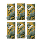 Gold Mistletoe Christmas napkins, set of six, folded on white, showing the same sprig of mistletoe with white berries