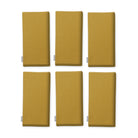 Plain gold cotton Christmas napkins, set of six, folded on white