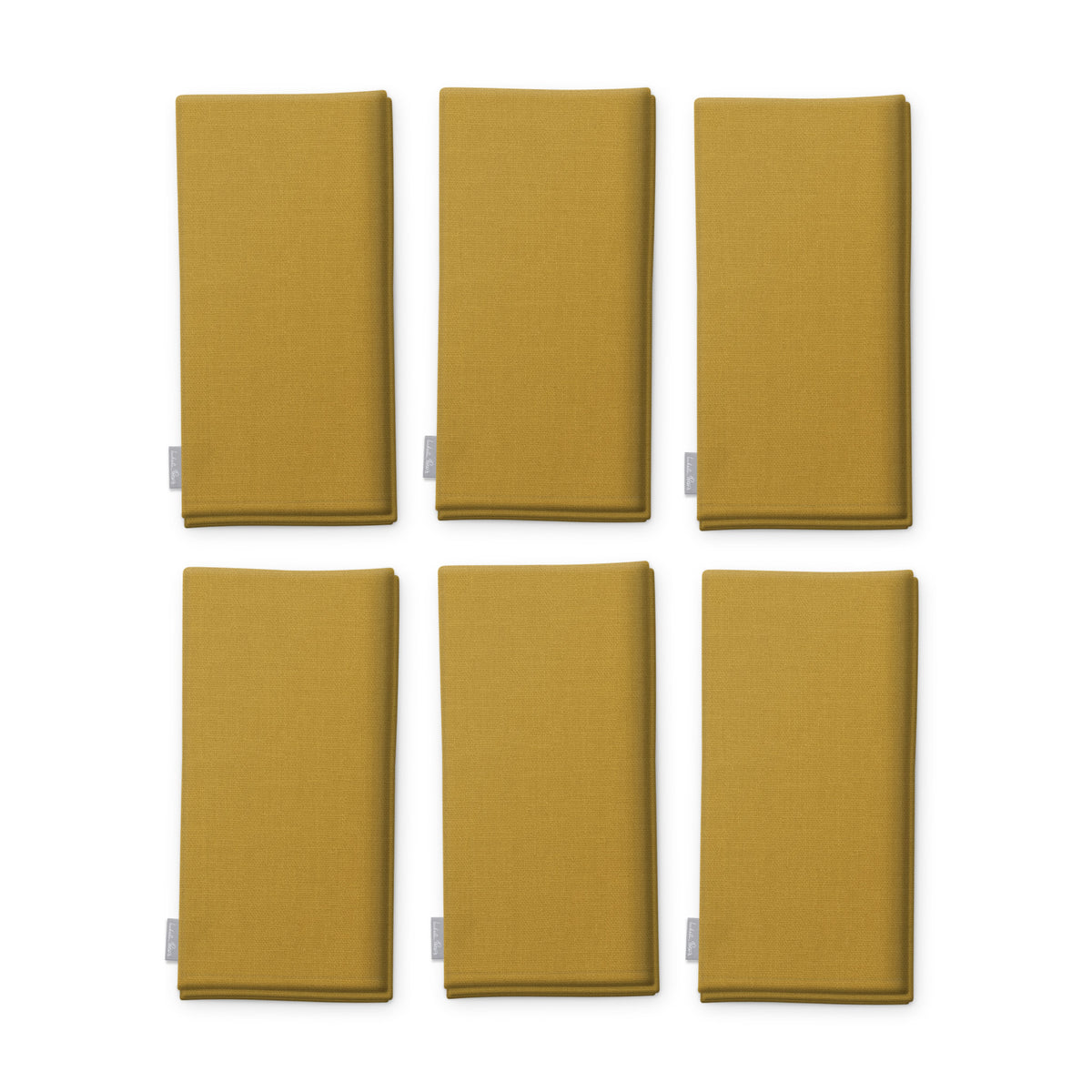 Plain gold cotton Christmas napkins, set of six, folded on white