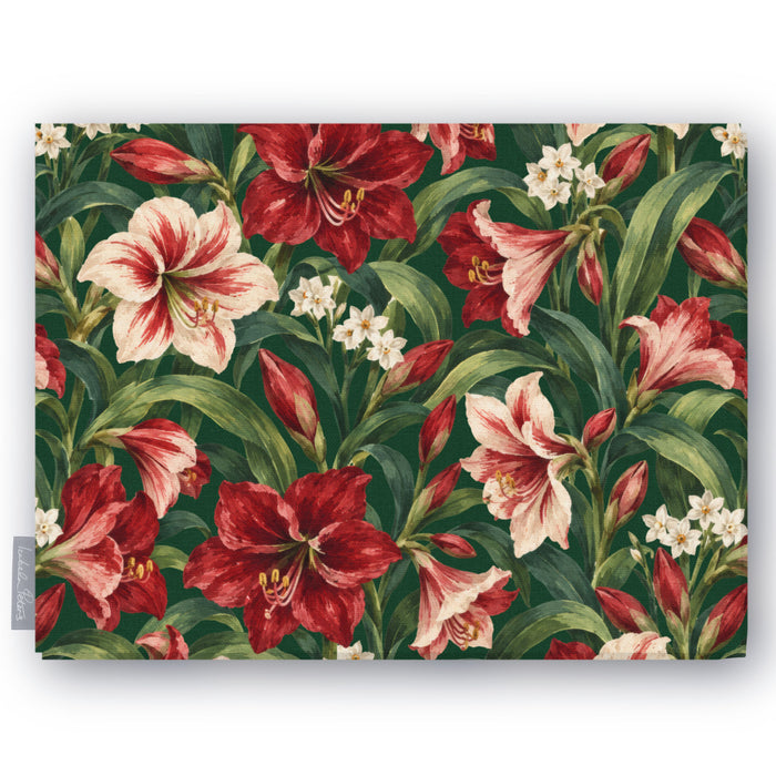 Green Amaryllis Christmas tablecloth folded on white, showing amaryllis flowers among long leaves