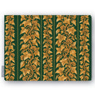 Gilded Ivy Christmas tablecloth in green and gold, folded on white, showing trails of gold ivy and berries