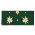 Stars Christmas table runner in green and gold, folded on white, showing large gold eight-pointed stars
