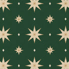 Close-up of the Stars Christmas tablecloth print in green and gold on cotton, showing gold eight-pointed stars