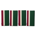 Signature Stripe Christmas napkins in green, burgundy and gold, set of four, folded on white, showing the same broad stripes