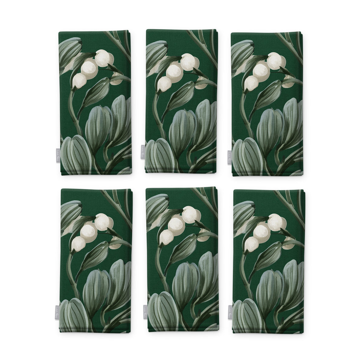 Green Mistletoe Christmas napkins, set of six, folded on white, showing the same sprig of mistletoe with white berries