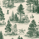 Close-up of the Fir Forest Toile Christmas tablecloth print in green on ivory cotton, showing fir trees and a rider