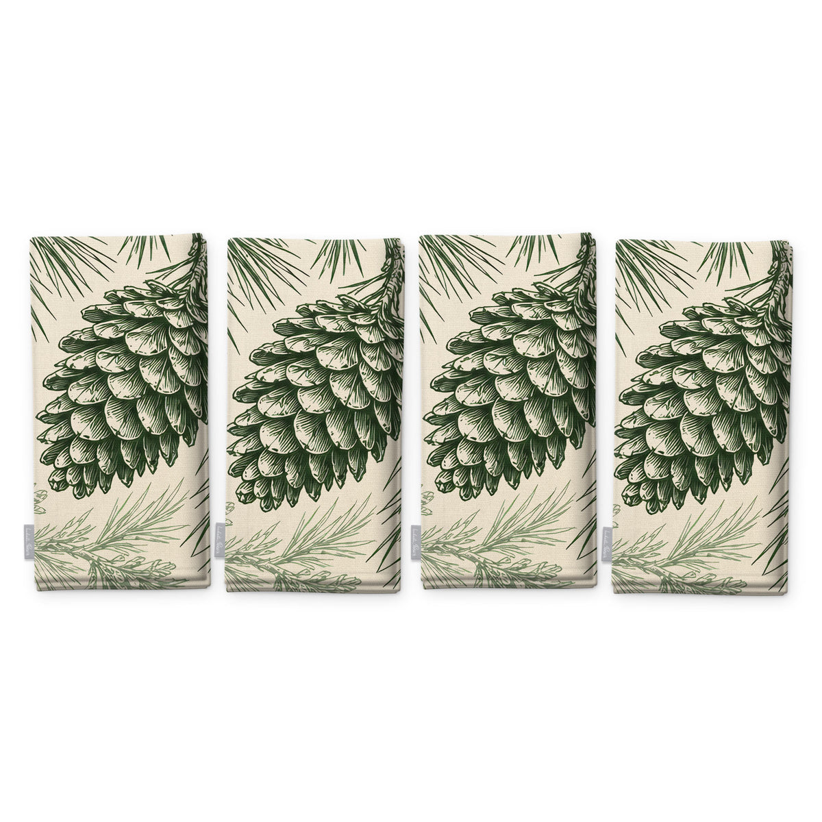 Pine Bough Christmas napkins in green on ivory, set of four, folded on white, showing the same pine cone on a bough
