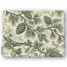 Pine Bough Christmas tablecloth in green on ivory, folded on white, showing pine boughs and cones