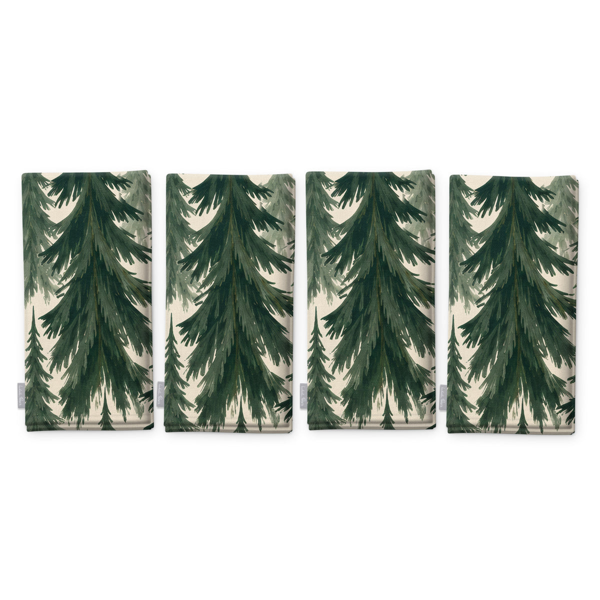 Spruce Stand Christmas napkins in green on ivory, set of four, folded on white, showing the same spruce trees