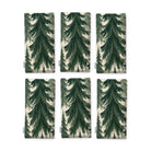 Spruce Stand Christmas napkins in green on ivory, set of six, folded on white, showing the same spruce trees