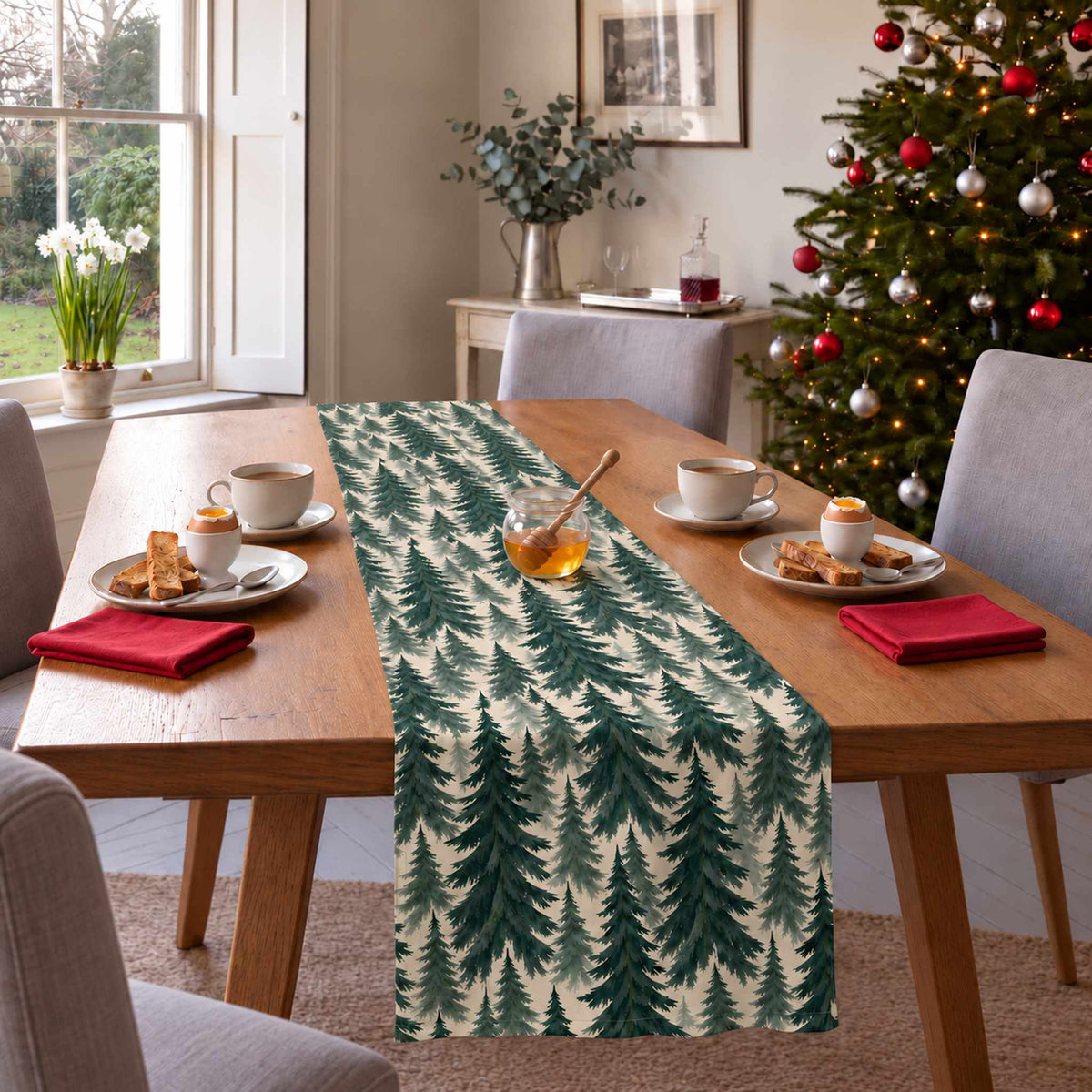 Spruce Stand Christmas table runner in Green on ivory, styled on a wooden table with a softly draped end in a daylight Christmas room.