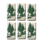 Village Toile Christmas napkins in green on ivory, set of six, folded on white, showing the same fir tree and snowy cottage