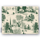 Village Toile Christmas tablecloth in green on ivory, folded on white, showing a snowy village with a church and cottages