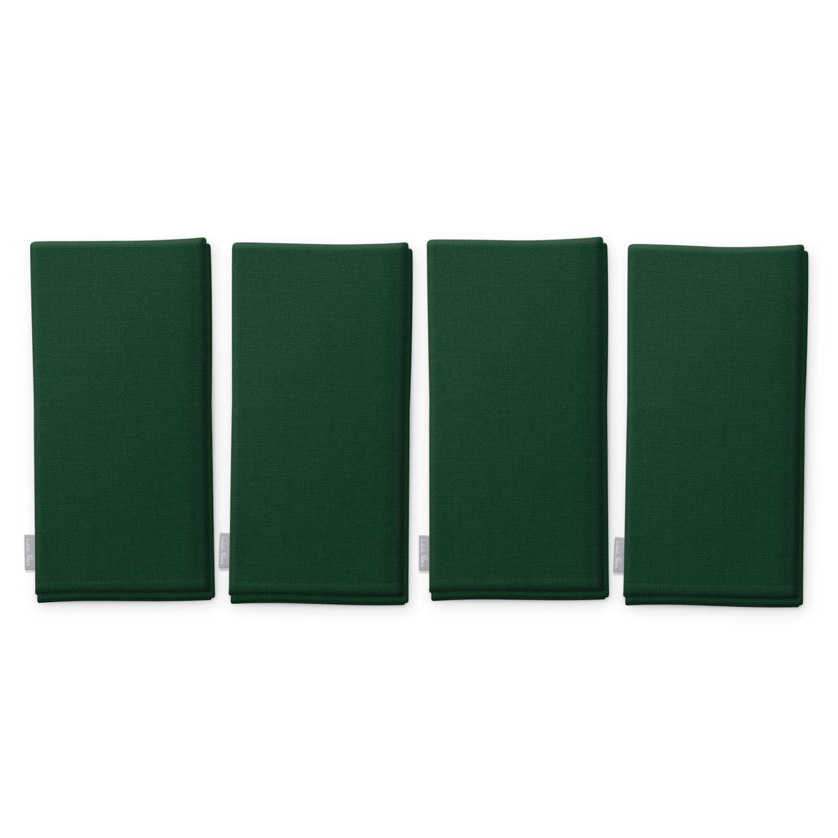 Plain green cotton Christmas napkins, set of four, folded on white