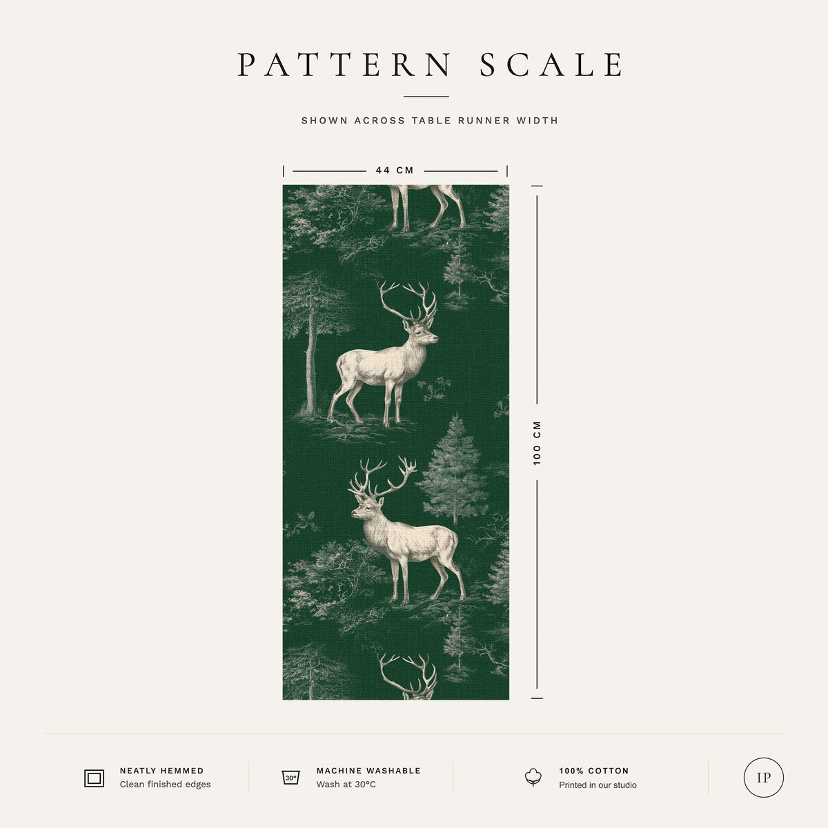Pattern scale of the green Stag Woodland Christmas table runner across its 44 cm width, with fabric and care notes