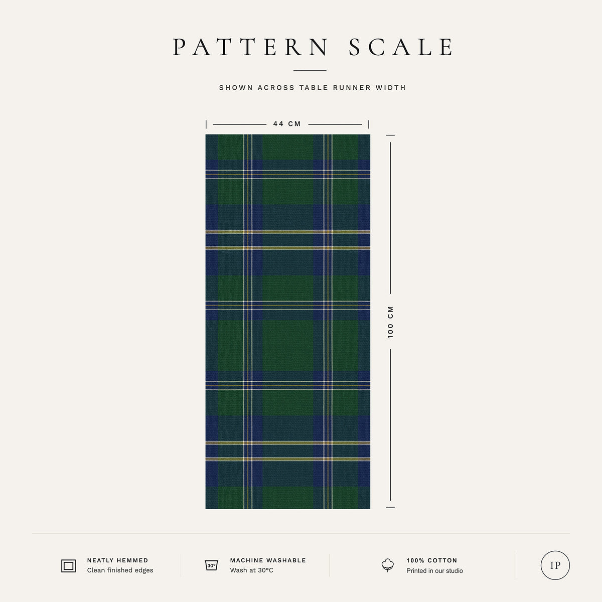 Pattern scale of the Tartan Christmas table runner in green across its 44 cm width, with care notes