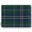 Green tartan Christmas tablecloth folded on a white background, green and navy with fine ivory and gold lines
