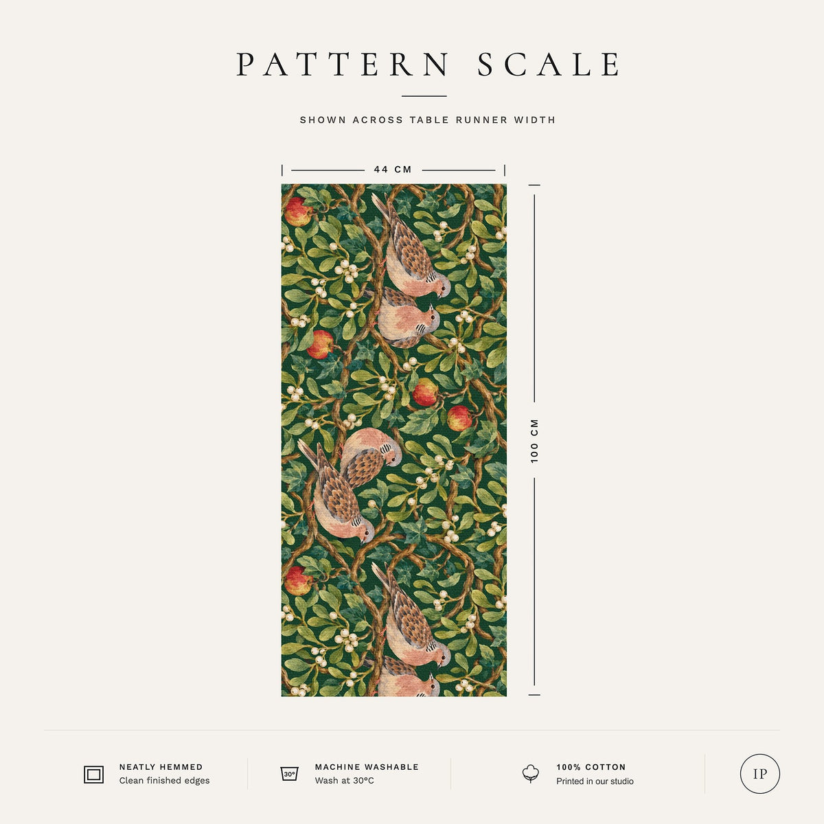Pattern scale of the Turtle Doves and Mistletoe Christmas table runner in green across its 44 cm width, with care notes