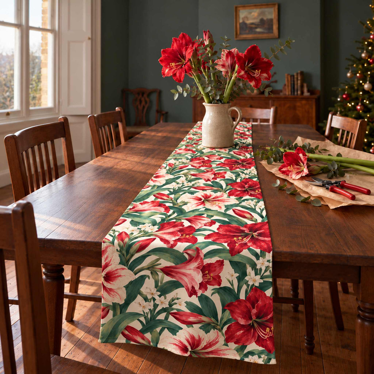 Amaryllis Christmas table runner in Ivory, styled on a wooden table with a softly draped end in a daylight Christmas room.