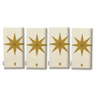 Stars Christmas napkins in ivory and gold, set of four, folded on white, showing the same large gold eight-pointed star