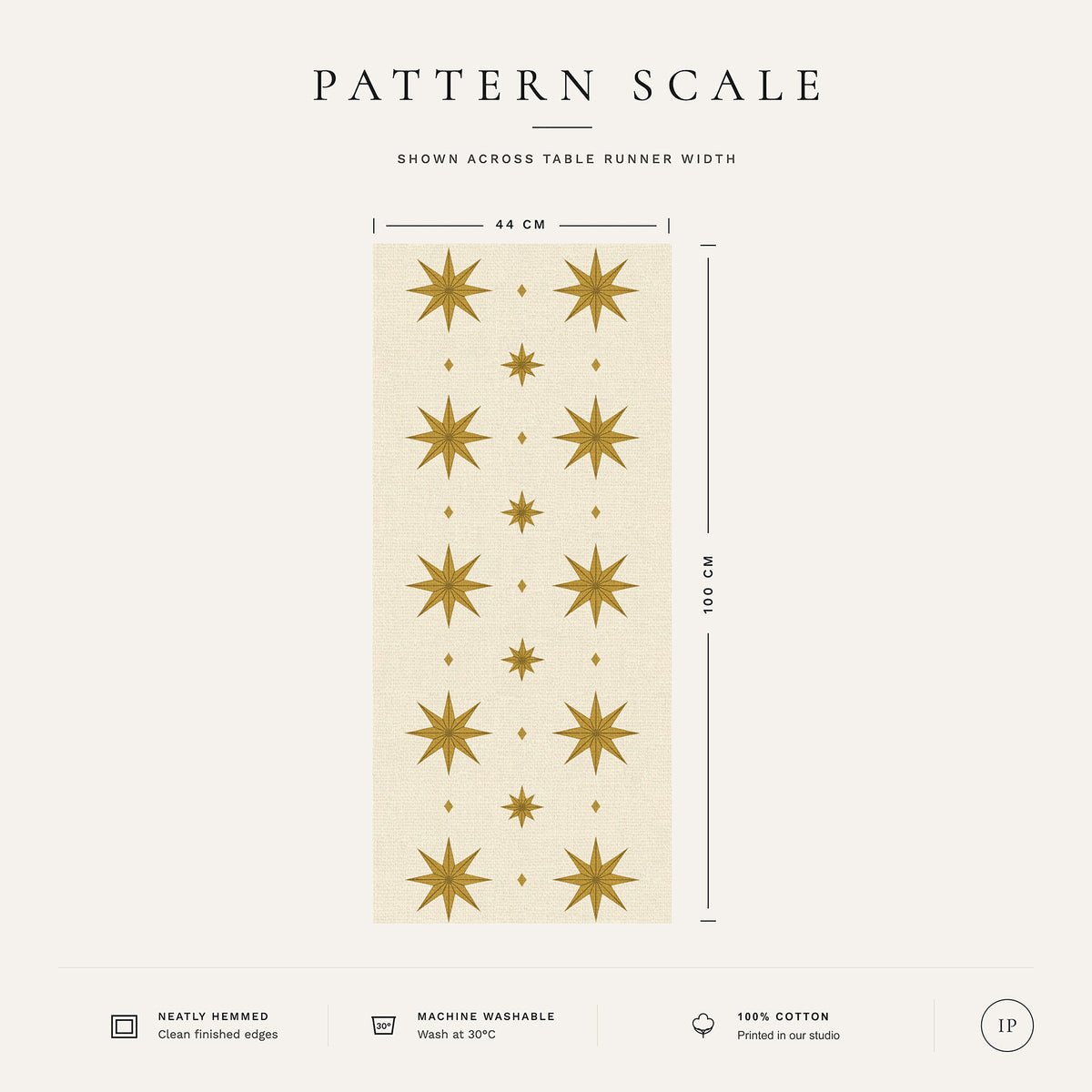 Pattern scale of the Stars Christmas table runner in ivory and gold across its 44 cm width, with care notes