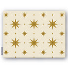 Stars Christmas tablecloth in ivory and gold, folded on white, showing gold eight-pointed stars