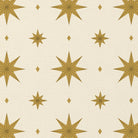Close-up of the Stars Christmas tablecloth print in ivory and gold on cotton, showing gold eight-pointed stars