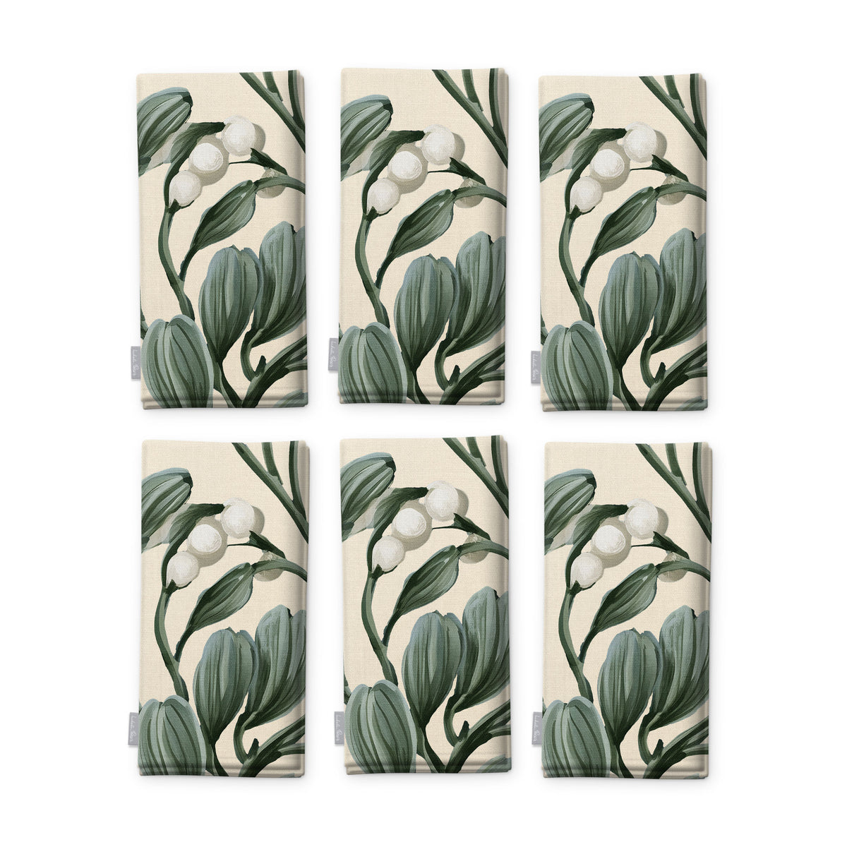 Ivory Mistletoe Christmas napkins, set of six, folded on white, showing the same sprig of mistletoe with white berries