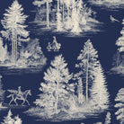 Close-up of the Fir Forest Toile Christmas table runner print in ivory on navy cotton, showing fir trees and a rider