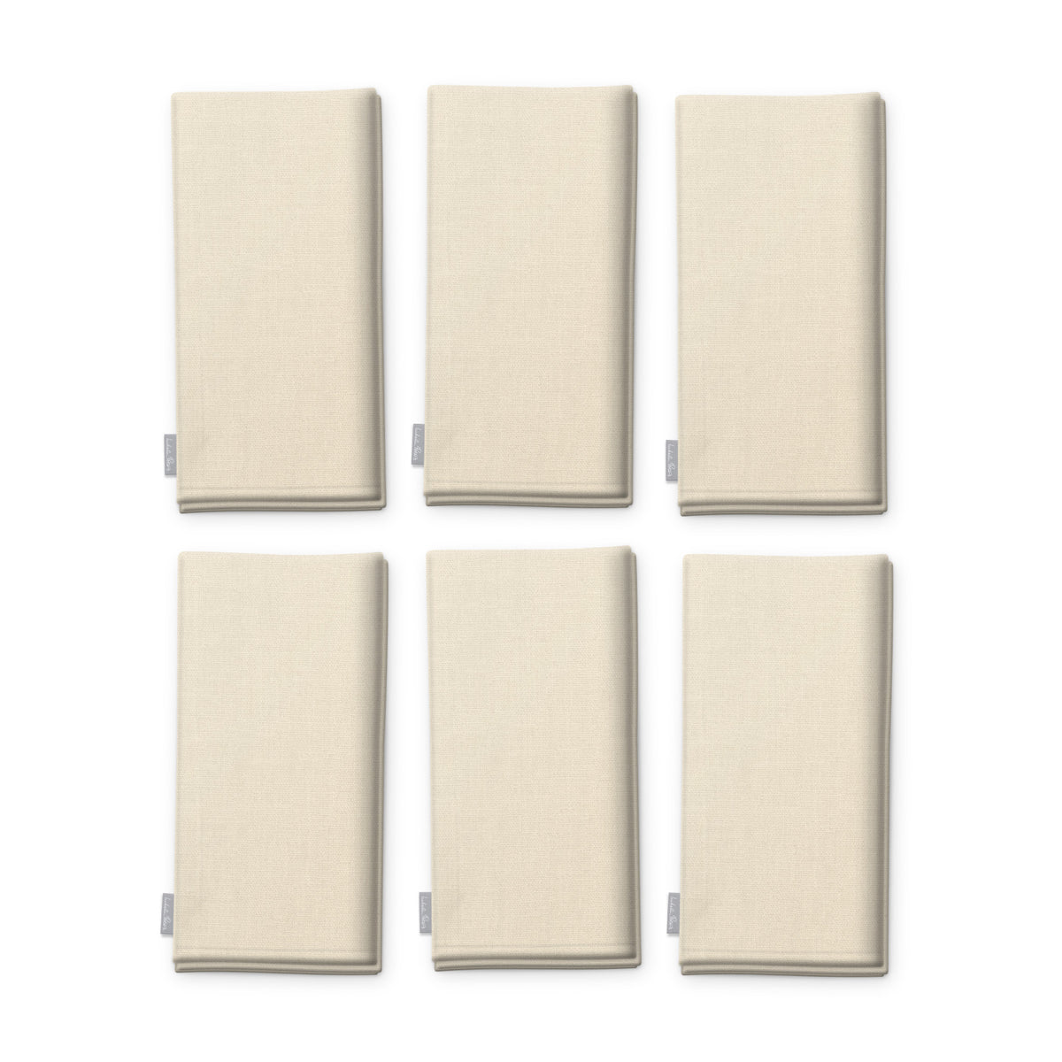 Plain ivory cotton Christmas napkins, set of six, folded on white