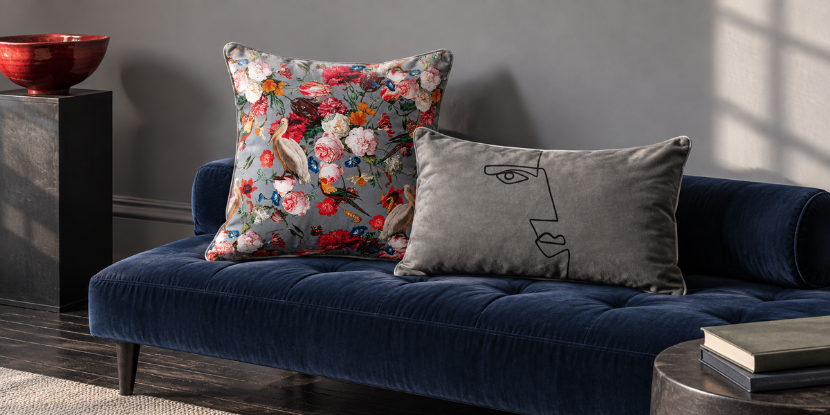 French Grey Peruvian Paradise and Beluga Angular Face velvet cushions on an indigo daybed.