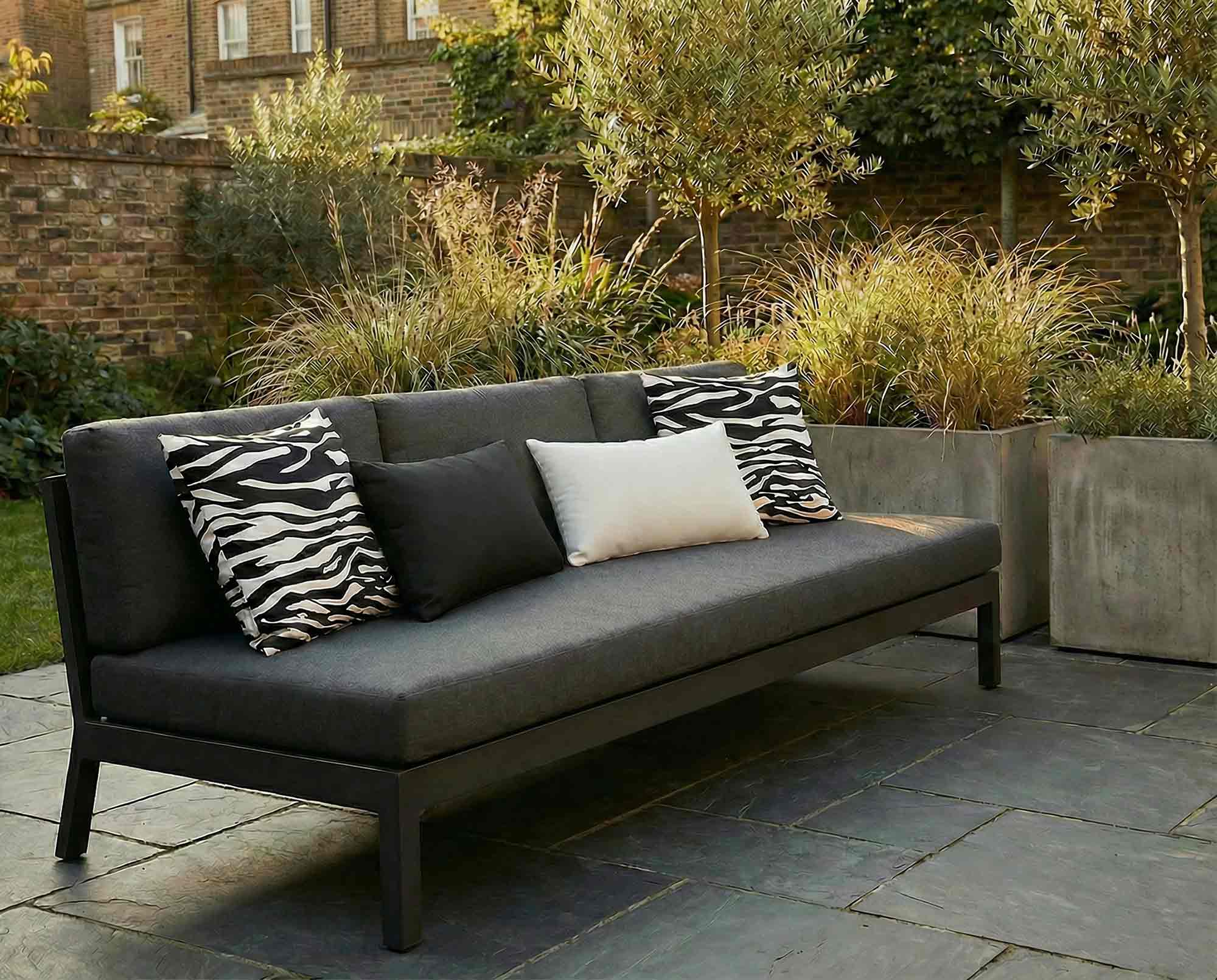 Outdoor cushions styled on a modern garden sofa in a contemporary patio setting