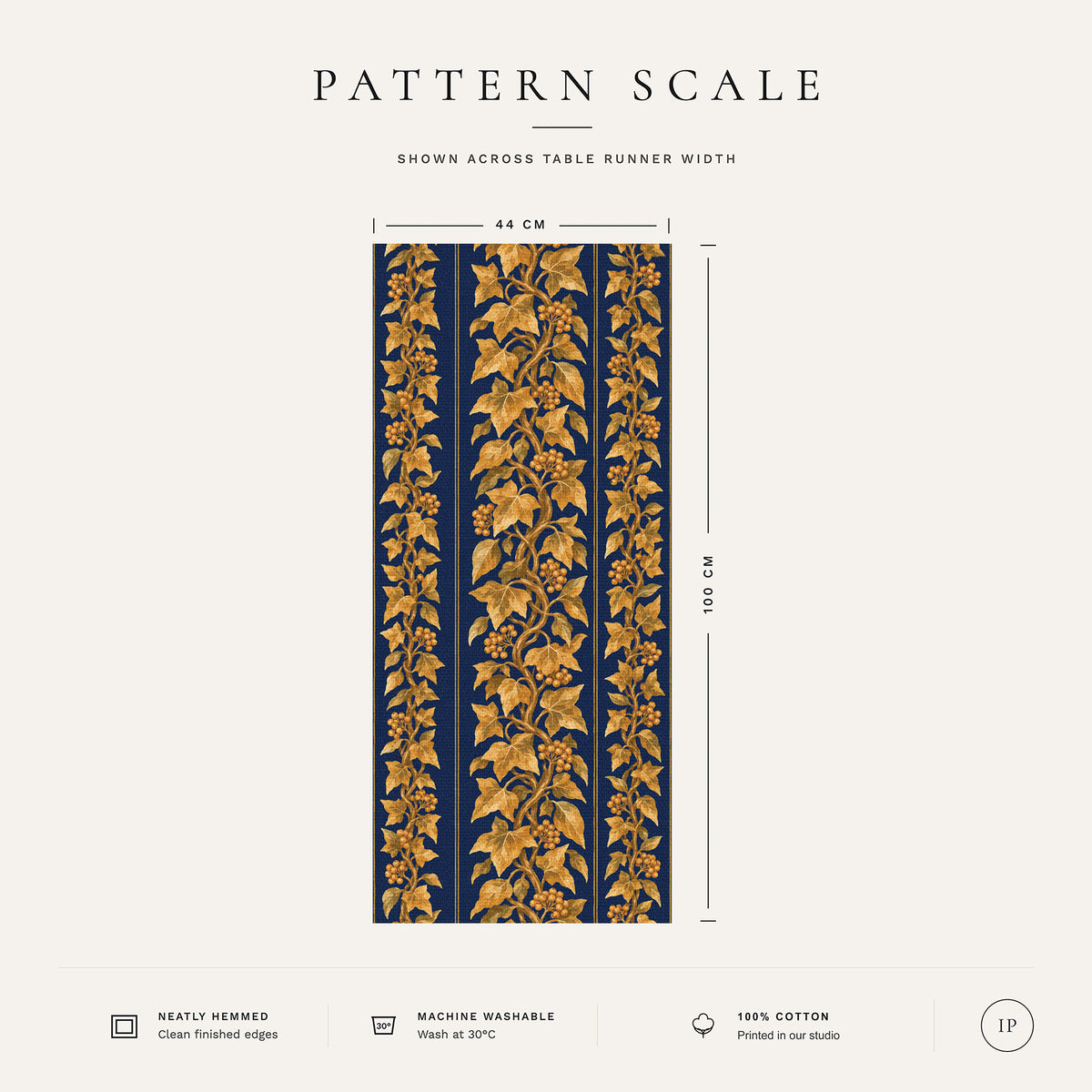 Pattern scale of the Gilded Ivy Christmas table runner in navy and gold across its 44 cm width, with care notes