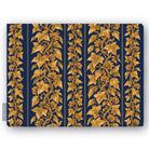 Gilded Ivy Christmas tablecloth in navy and gold, folded on white, showing trails of gold ivy and berries