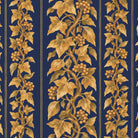 Close-up of the Gilded Ivy Christmas tablecloth print in navy and gold on cotton, showing trails of gold ivy and berries
