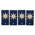 Stars Christmas napkins in navy and gold, set of four, folded on white, showing the same large gold eight-pointed star
