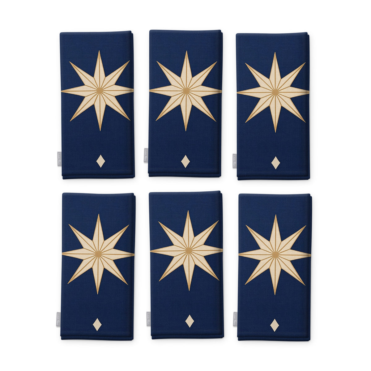 Stars Christmas napkins in navy and gold, set of six, folded on white, showing the same large gold eight-pointed star