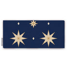 Stars Christmas table runner in navy and gold, folded on white, showing large gold eight-pointed stars